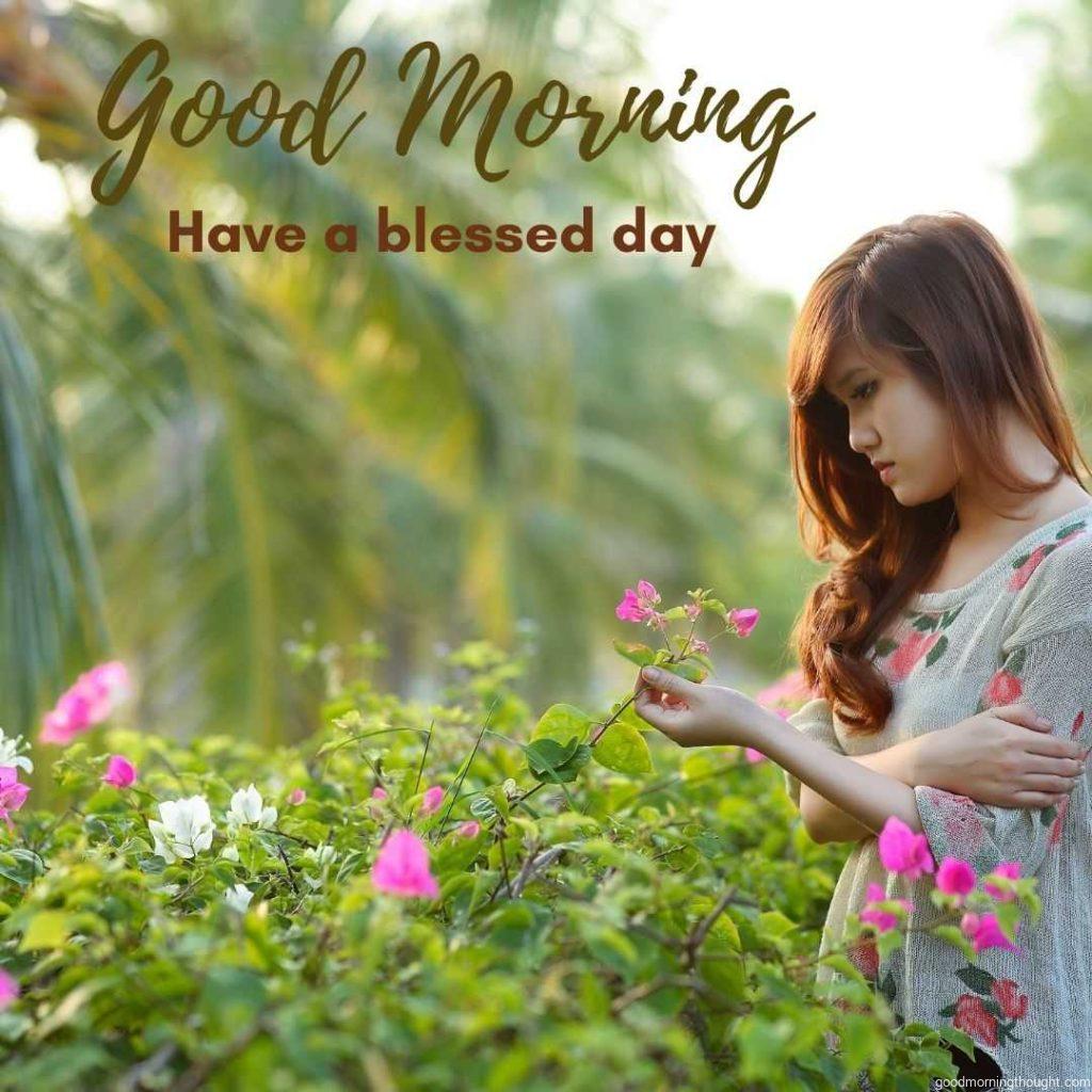 Beautiful girl in garden picking flowers in morning