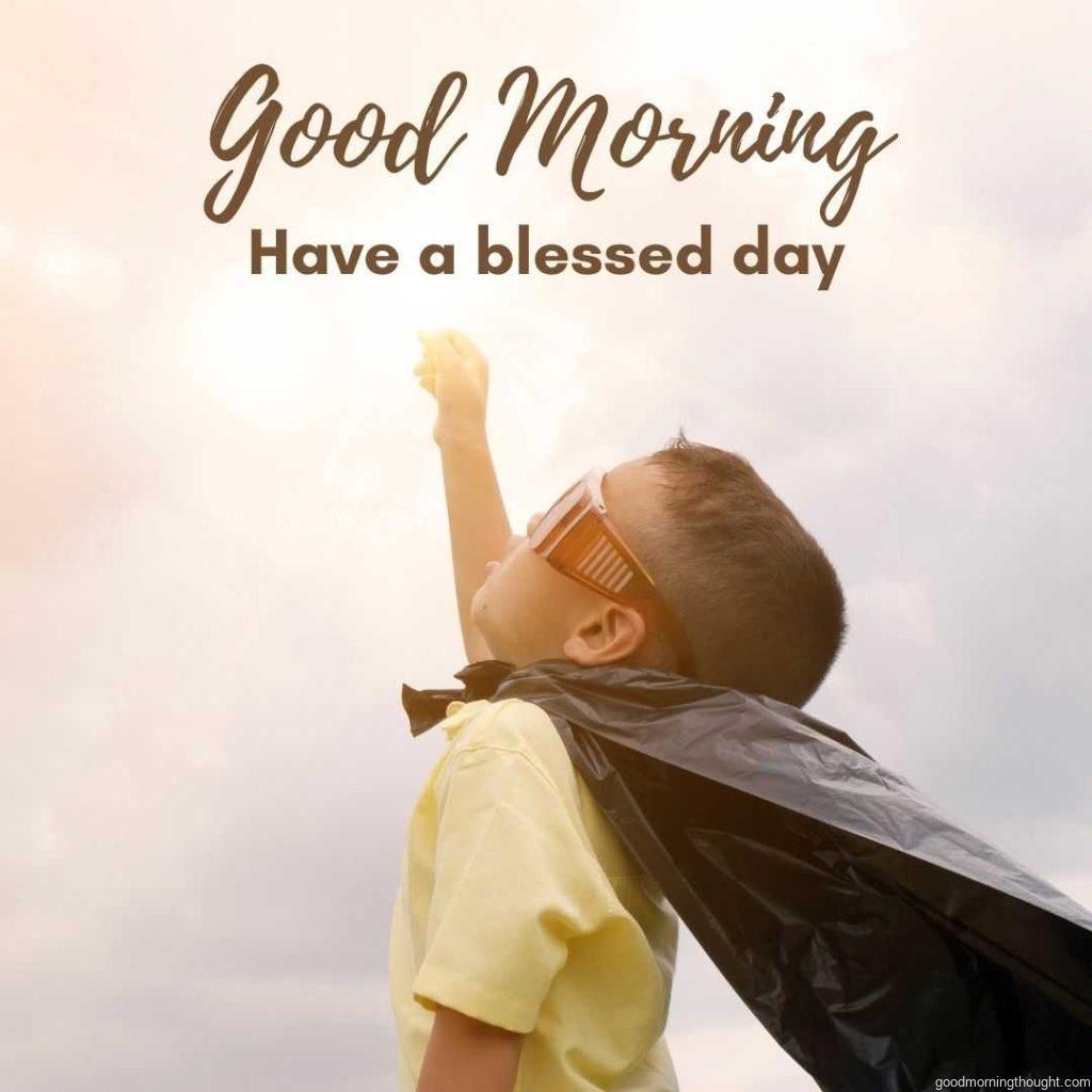 Little boy looks like superman looking at the sky. Good morning greeting with blessed day.