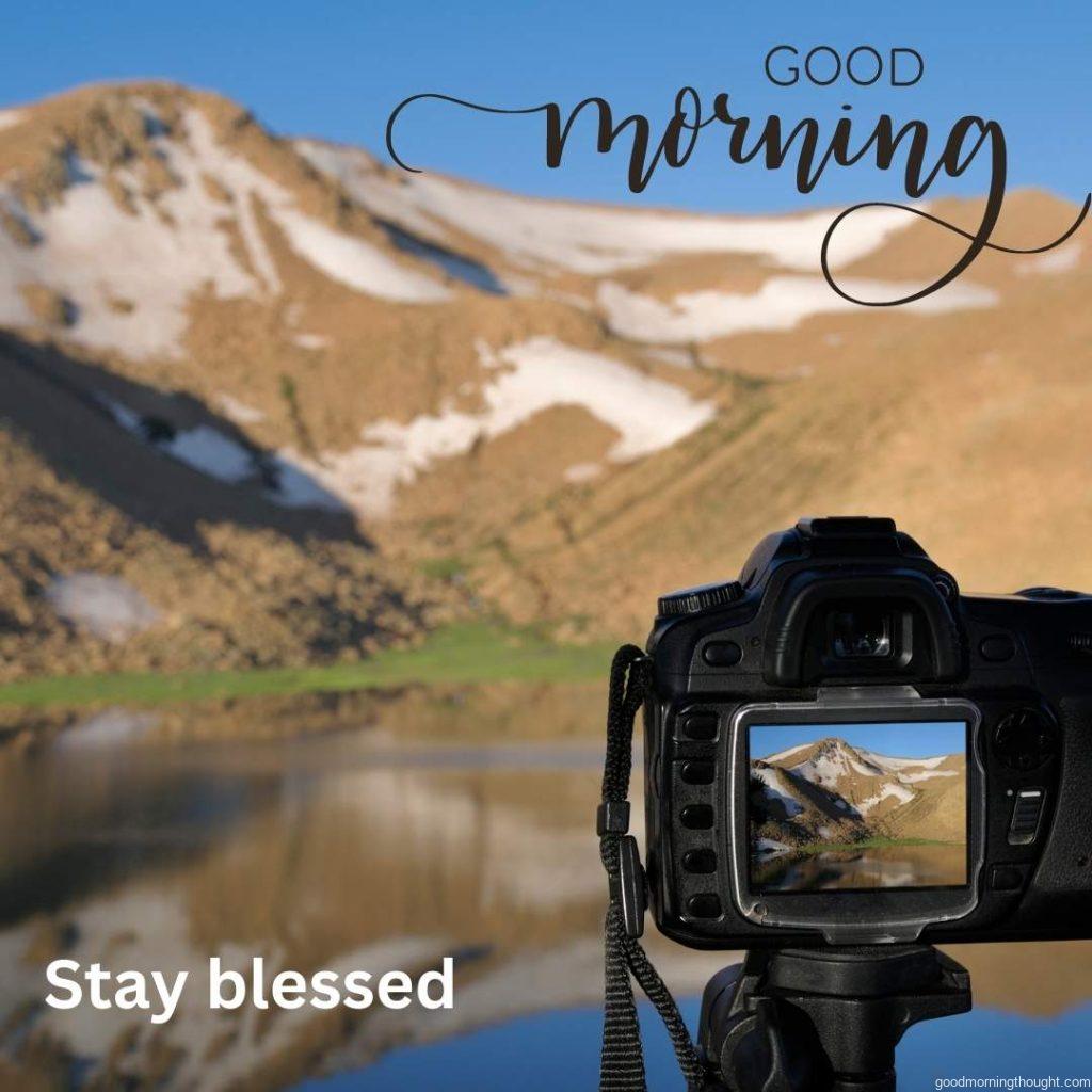 Focus is on camera with icy mountain