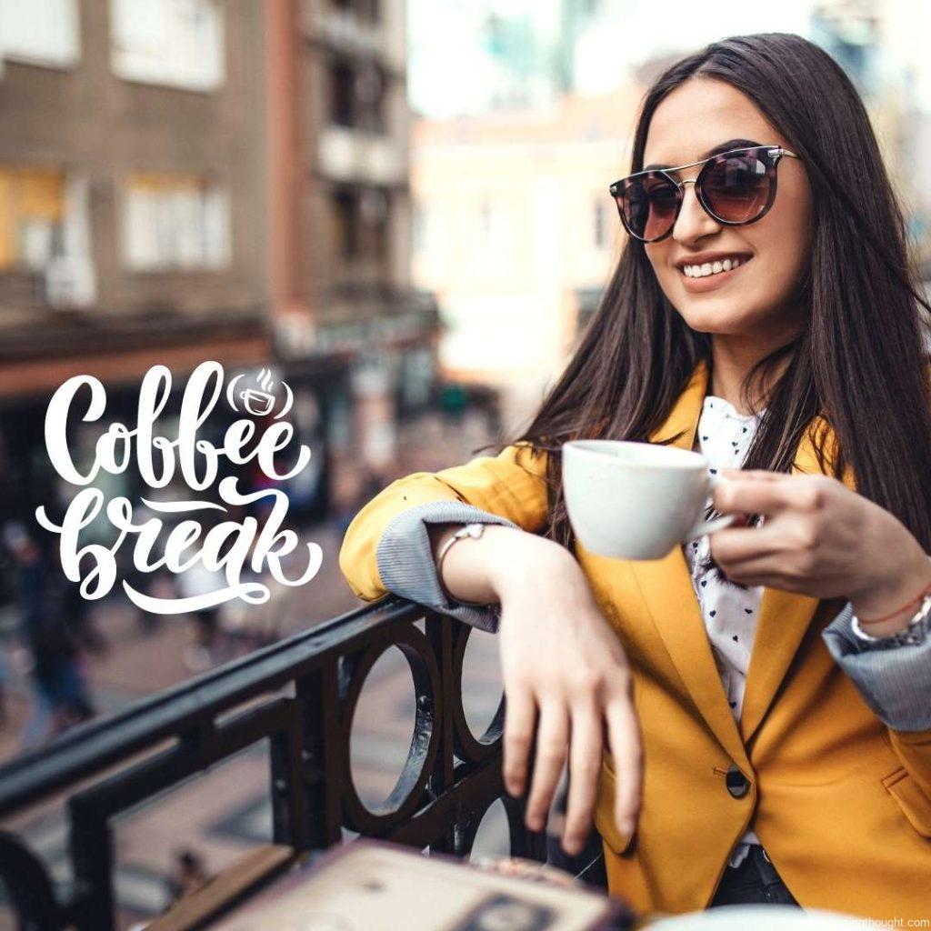 Beautiful women drinking coffee on balcony of the cafe