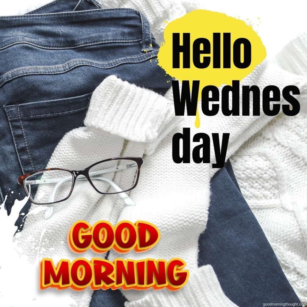 Black frame eye glass on white sweater and blue jeans with hello Wednesday message