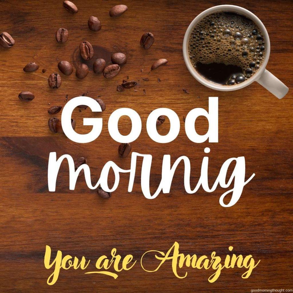 Coffee cup and coffee beans on dark wooden table with good morning message