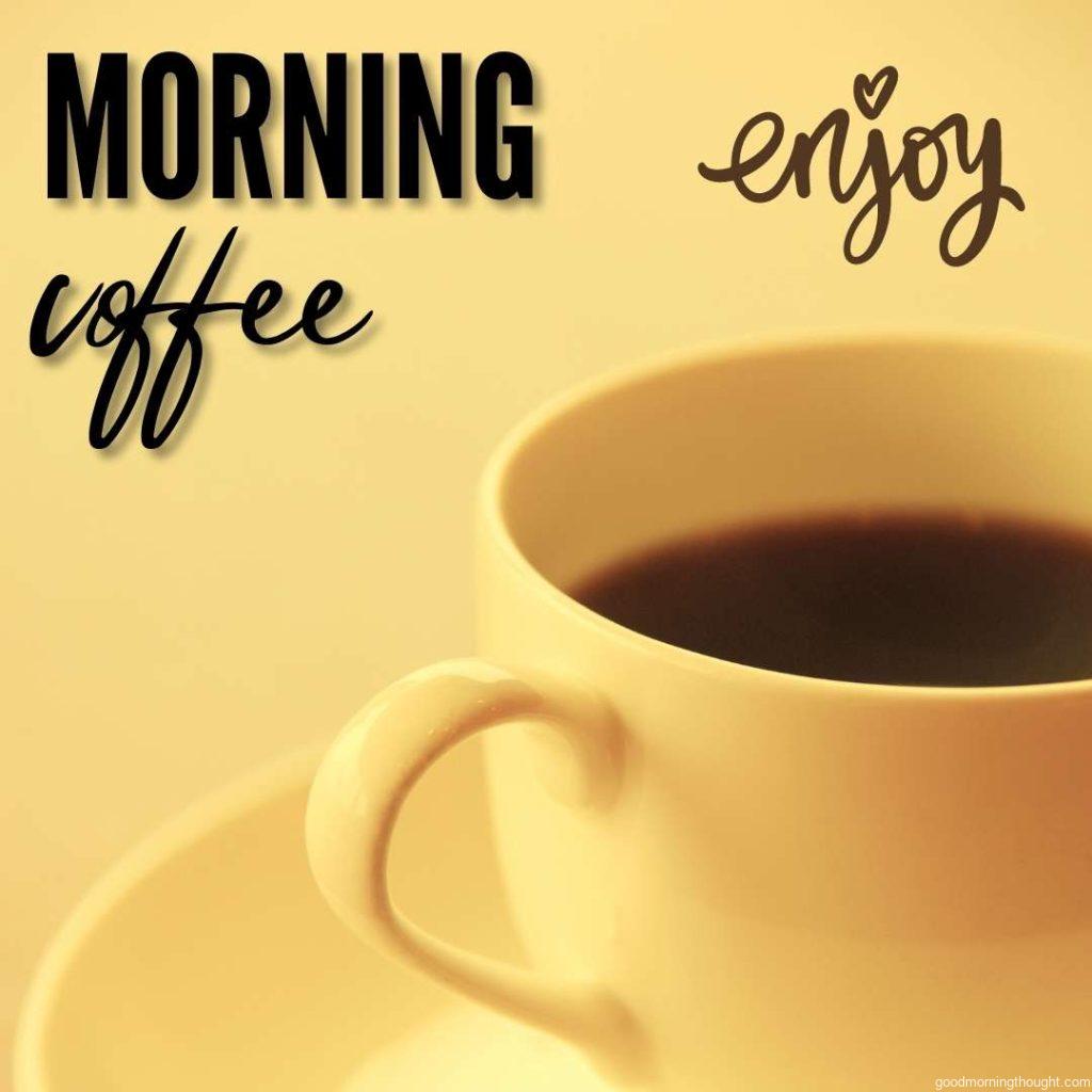 Coffee in pale yellow cup on pale yellow background with morning coffee and enjoy text lettering