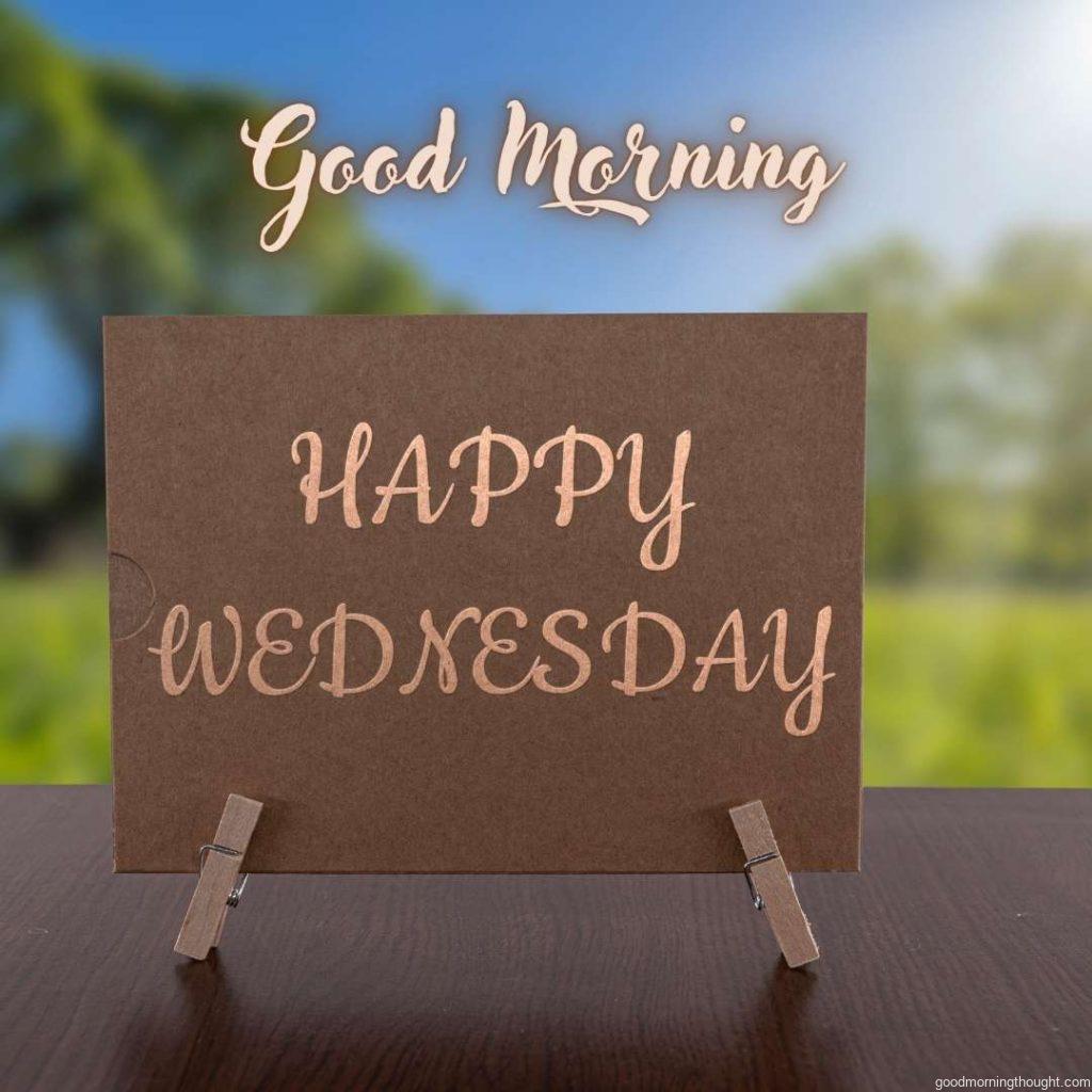 Happy Wednesday card on the table with sunny green forest background