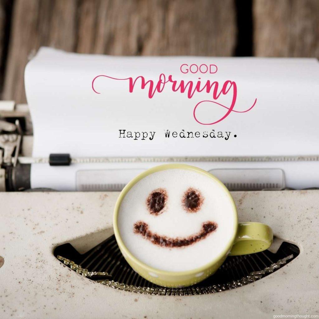 Happy Wednesday on typewriter with happy face coffee cup. Good Morning Wednesday Image.