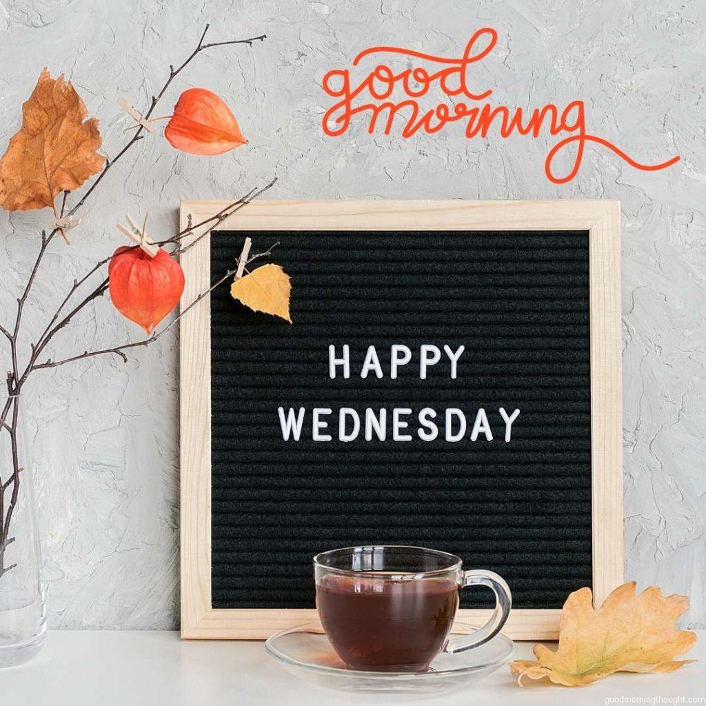 Happy Wednesday text on black letter board and bouquet of branches with yellow leaves. Good Morning Wednesday Image