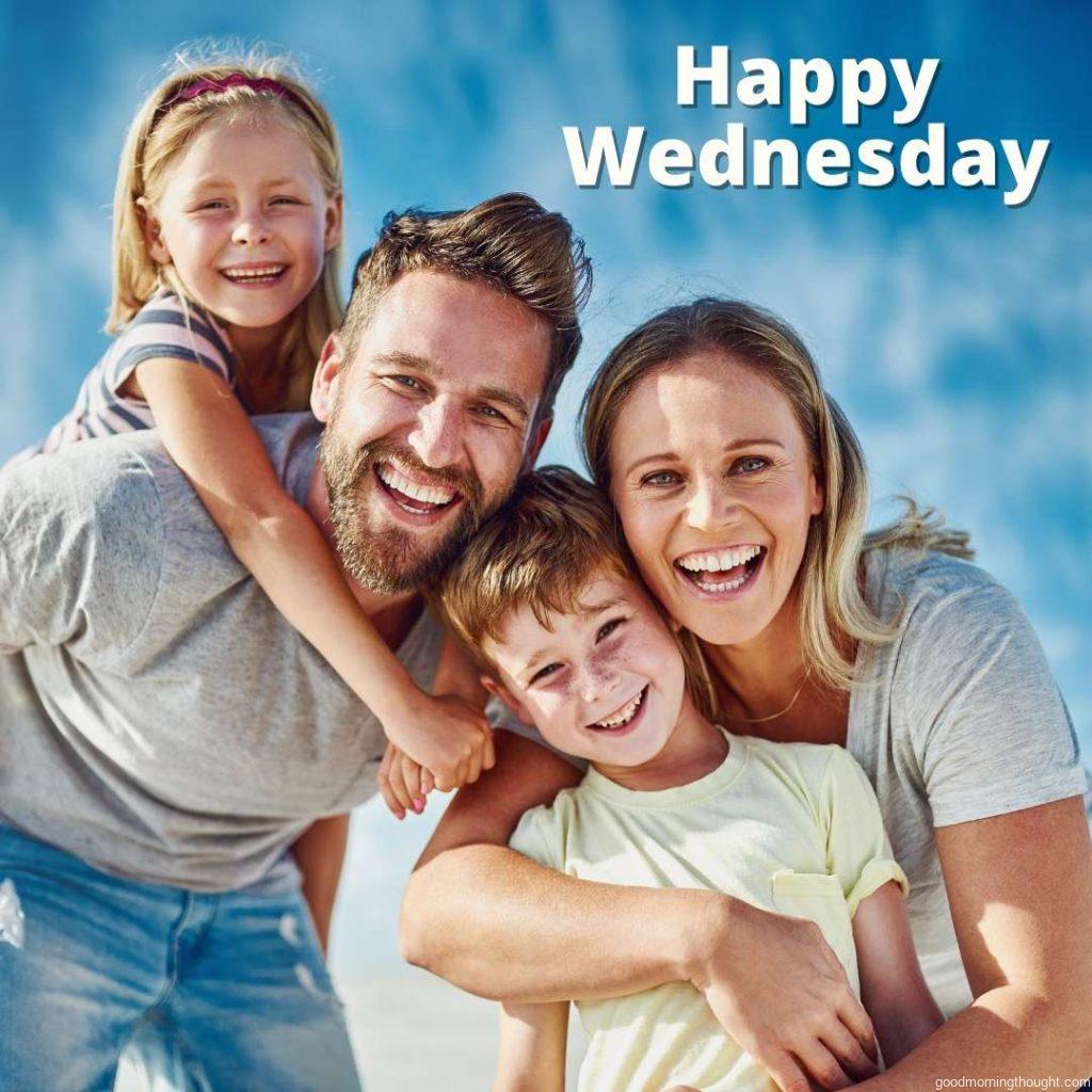 Happy family with small children enjoying lovely Wednesday morning at beach