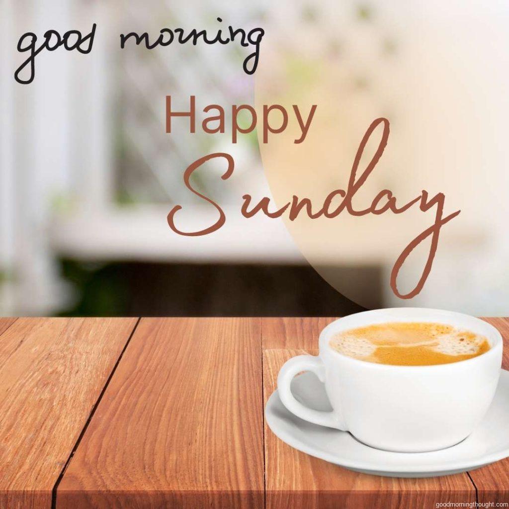 wooden table over blurred background with cup of tea. Good Morning Sunday Image