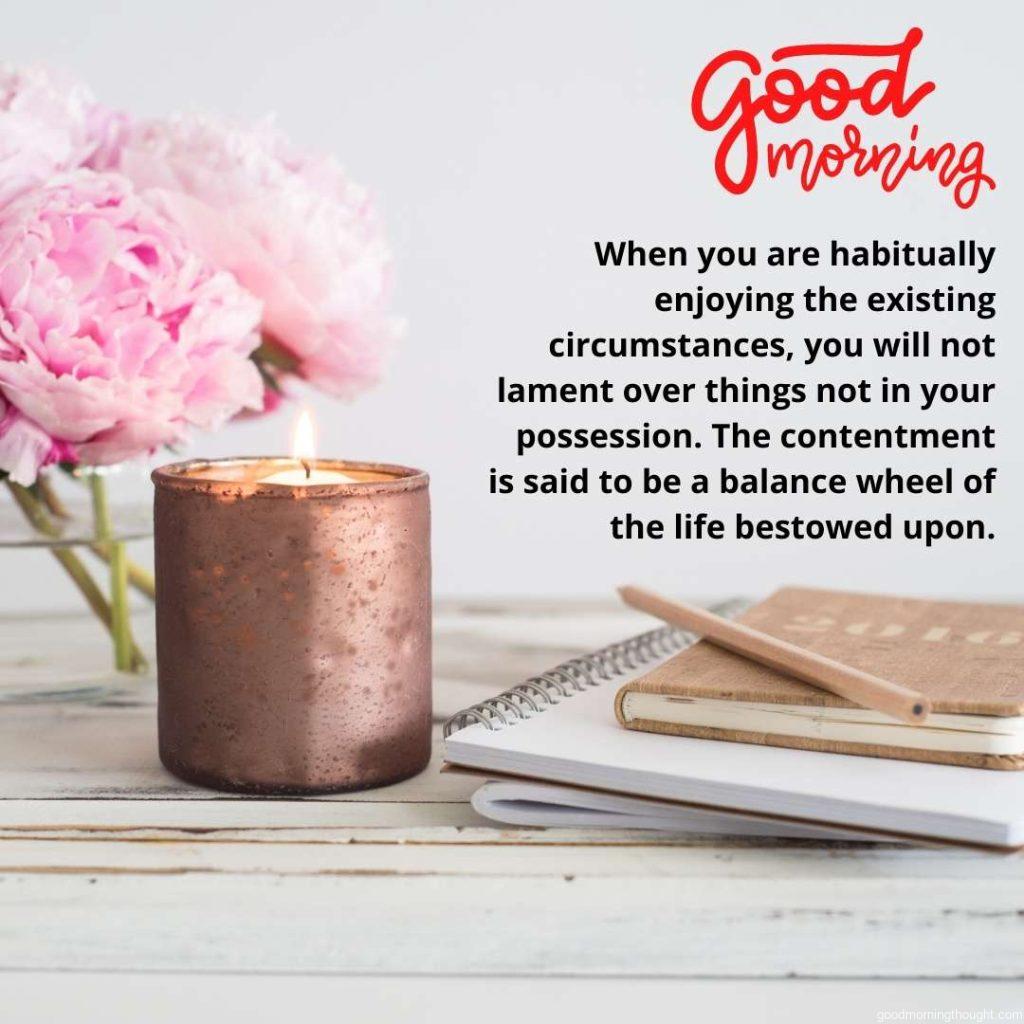 flowers and candle with note pad at background and beautiful good morning quote