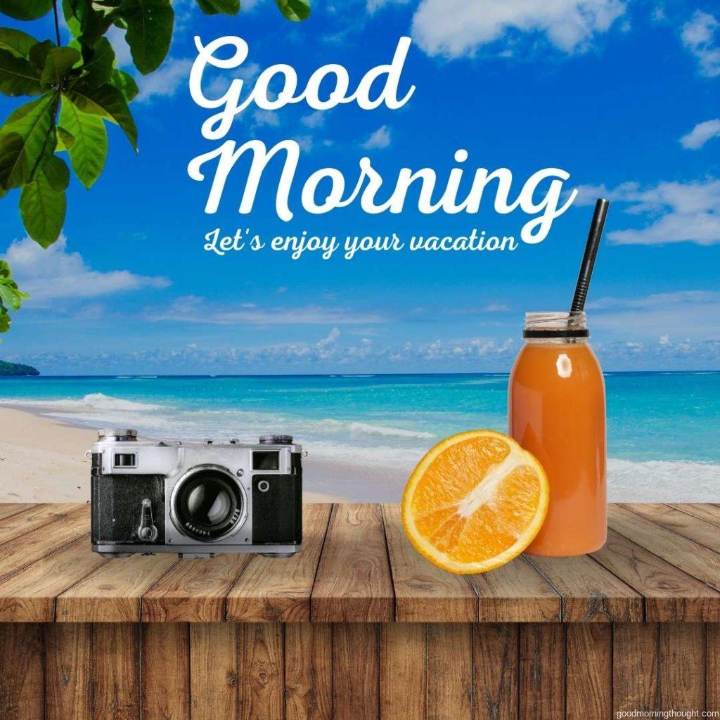 Beautiful beach view in the morning. Bottle of Orange Juice with Straw and Slice of Fruit and vintage film camera