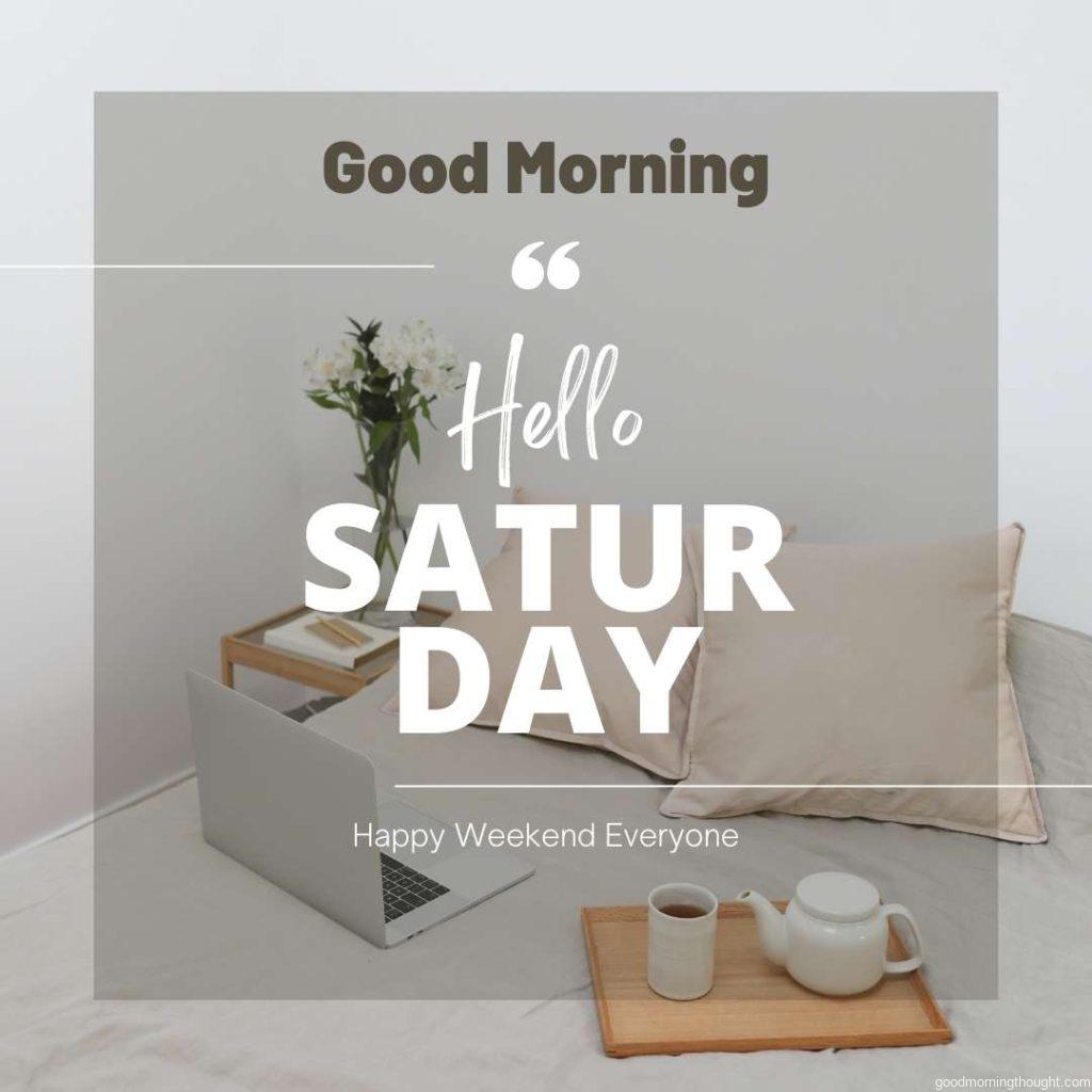 Comfortable bed with a netbook and coffee set during the weekend, _Good Morning, Hello Saturday_ text