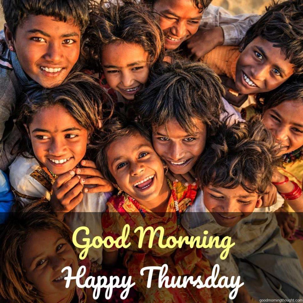 Group of happy Gipsy Indian children in a desert village, Thar Desert, Rajasthan, India, with _Good Morning, Happy Thursday Images_ text