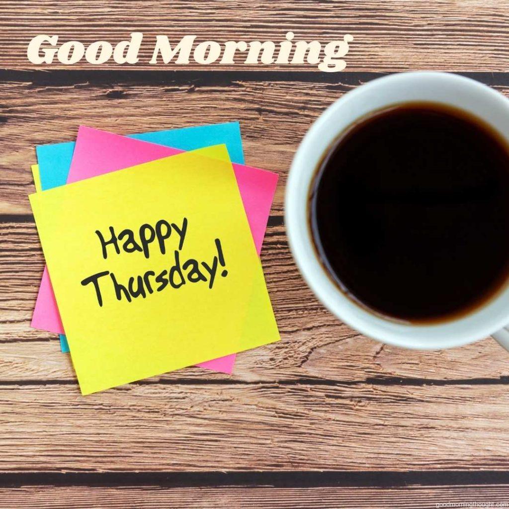 Happy Thursday quotes on a paper note with a cup of coffee and a pen with _Good Morning, Happy Thursday_ text