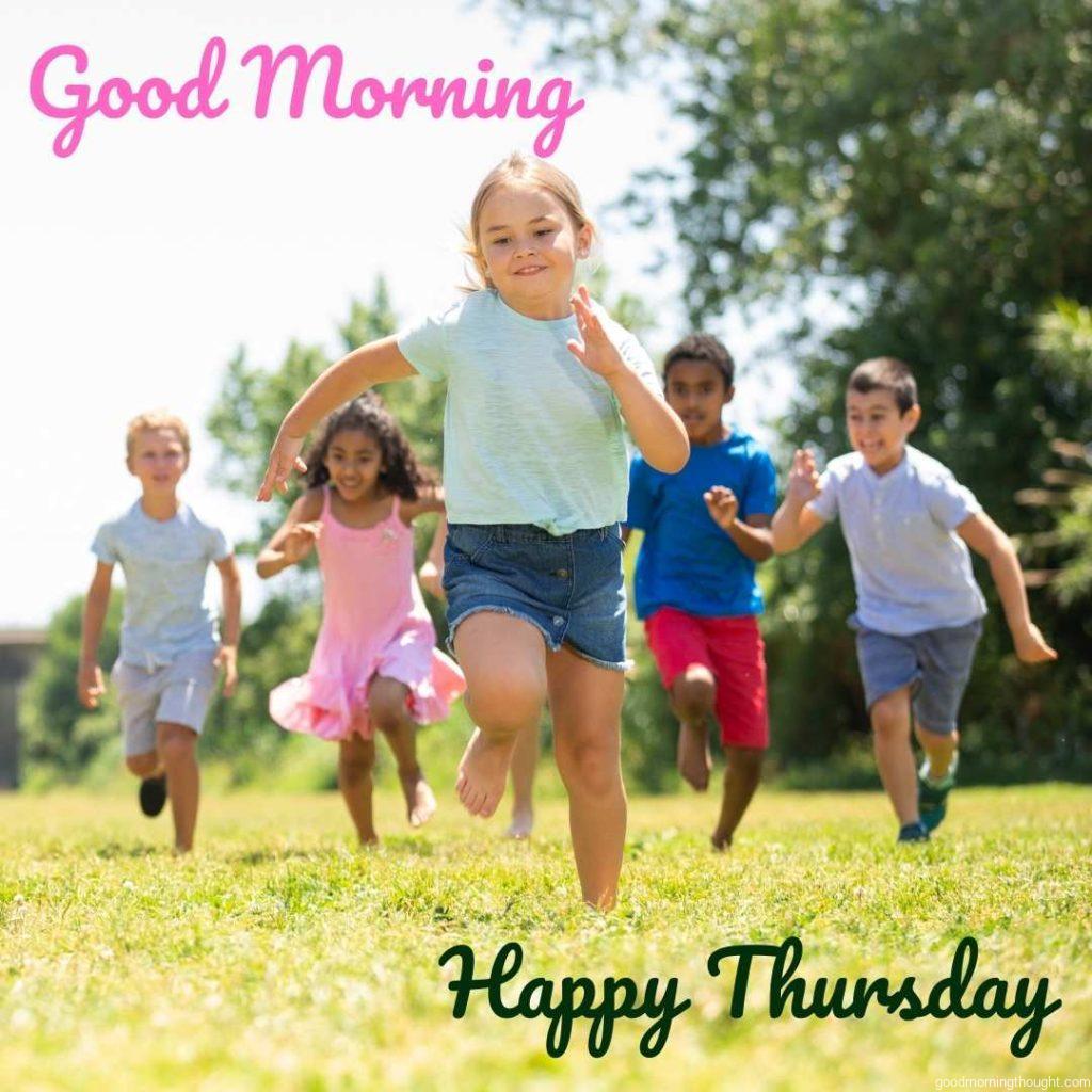 Happy kids are running in a race in the street and laughing in the background, to which _Good Morning, Happy Thursday Images_ text