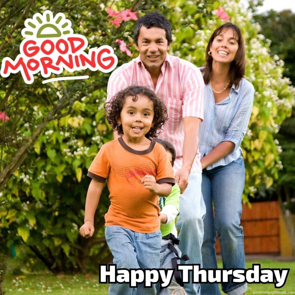 In the background, Happy Family Having Fun Outdoors, on which _Good Morning, Happy Thursday_ text appears