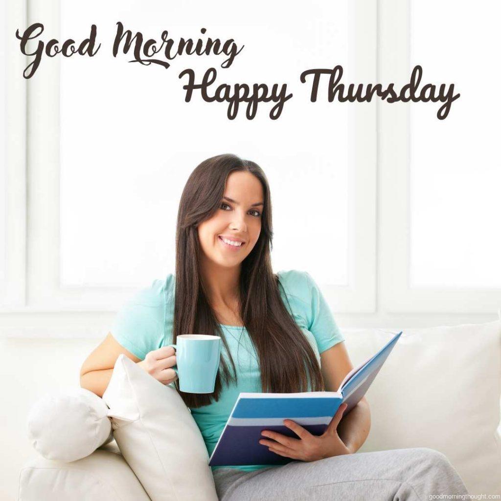 Portrait of a happy young Caucasian brunette holding a blue cup and a book in the background and a _Good Morning, Happy Thursday_ text