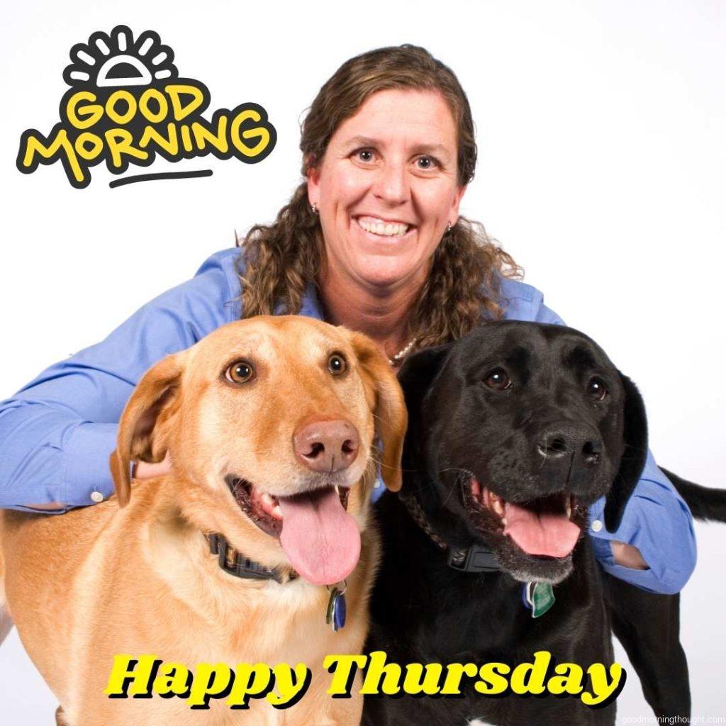 This dog lover poses with her two pups in the background, on which _Good Morning, Happy Thursday_ text appears