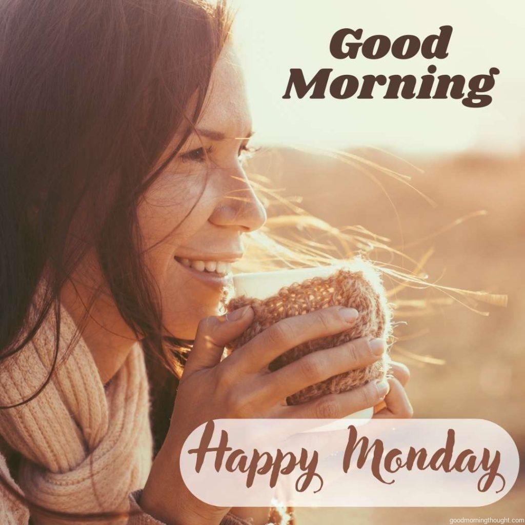 Woman wearing warm knit clothes drinking a cup of hot tea or coffee outdoors in sunlight in the background and on to which _Good morning, happy Monday text