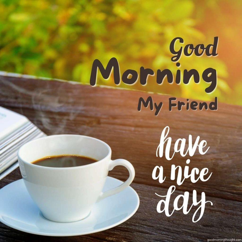 A coffee-cup clock and a newspaper are displayed on an old wooden table against a natural backdrop. Good morning images for friends