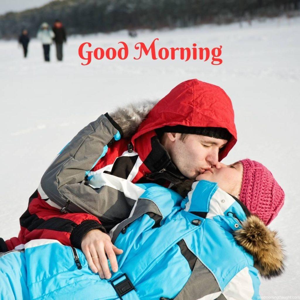 A lovely couple kissing in the snowy outdoors, Love Romantic Kiss Good Morning Image