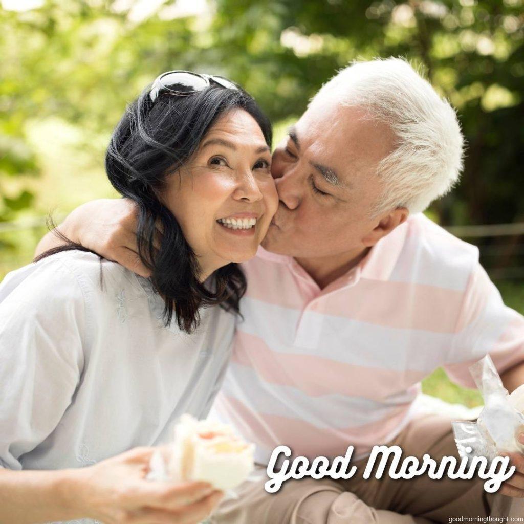 A senior Asian couple enjoys time together at a picnic outdoors at a public park in Taipei. Love Romantic Kiss Good Morning Image