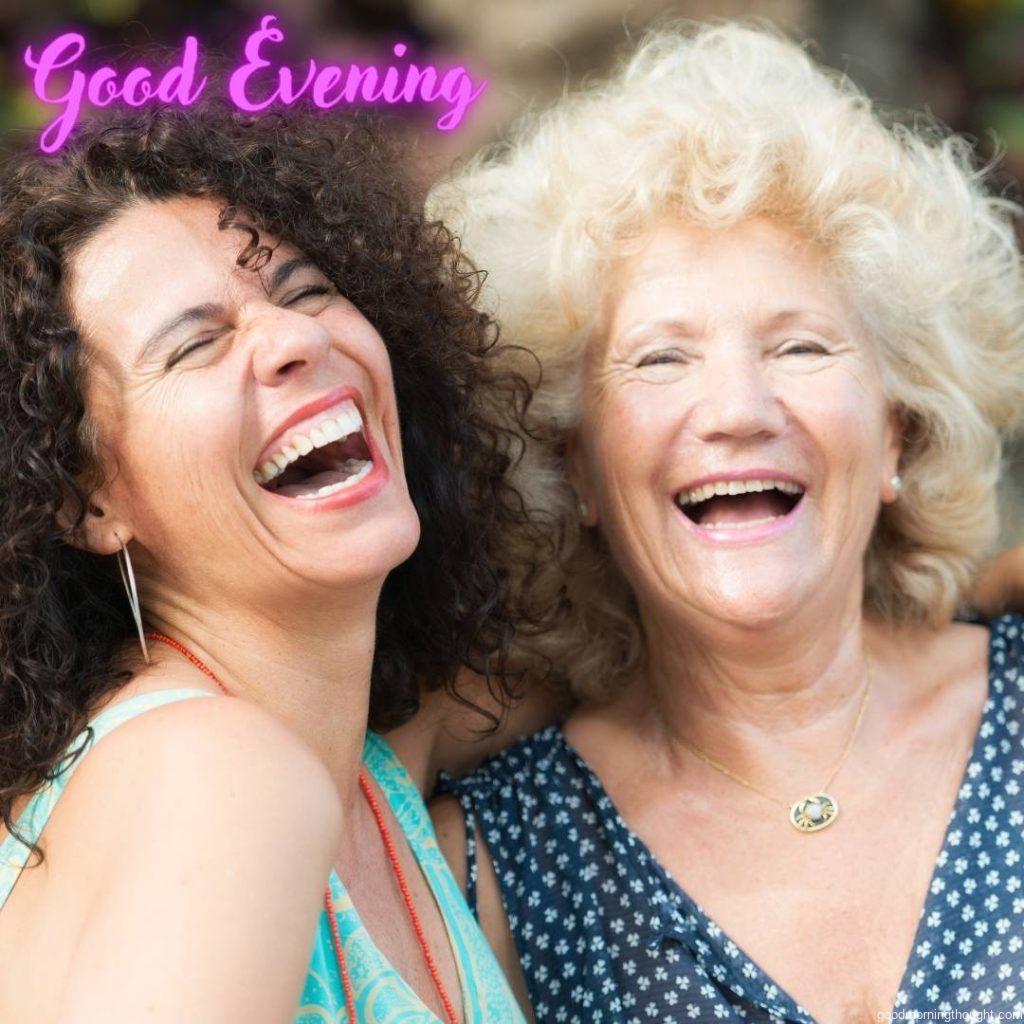 A senior woman laughs with her daughter. Good evening images