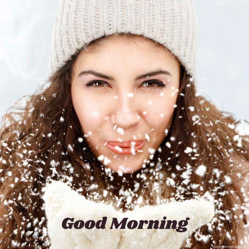 A young woman blows snowflakes from her hands. Good Morning, Winter Images