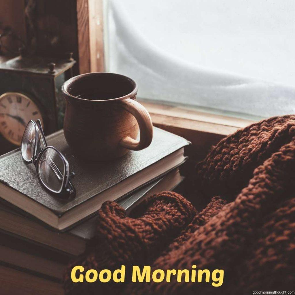 Book, cup of tea, and sweater on a wooden window sill in an old house, Good morning, winter images