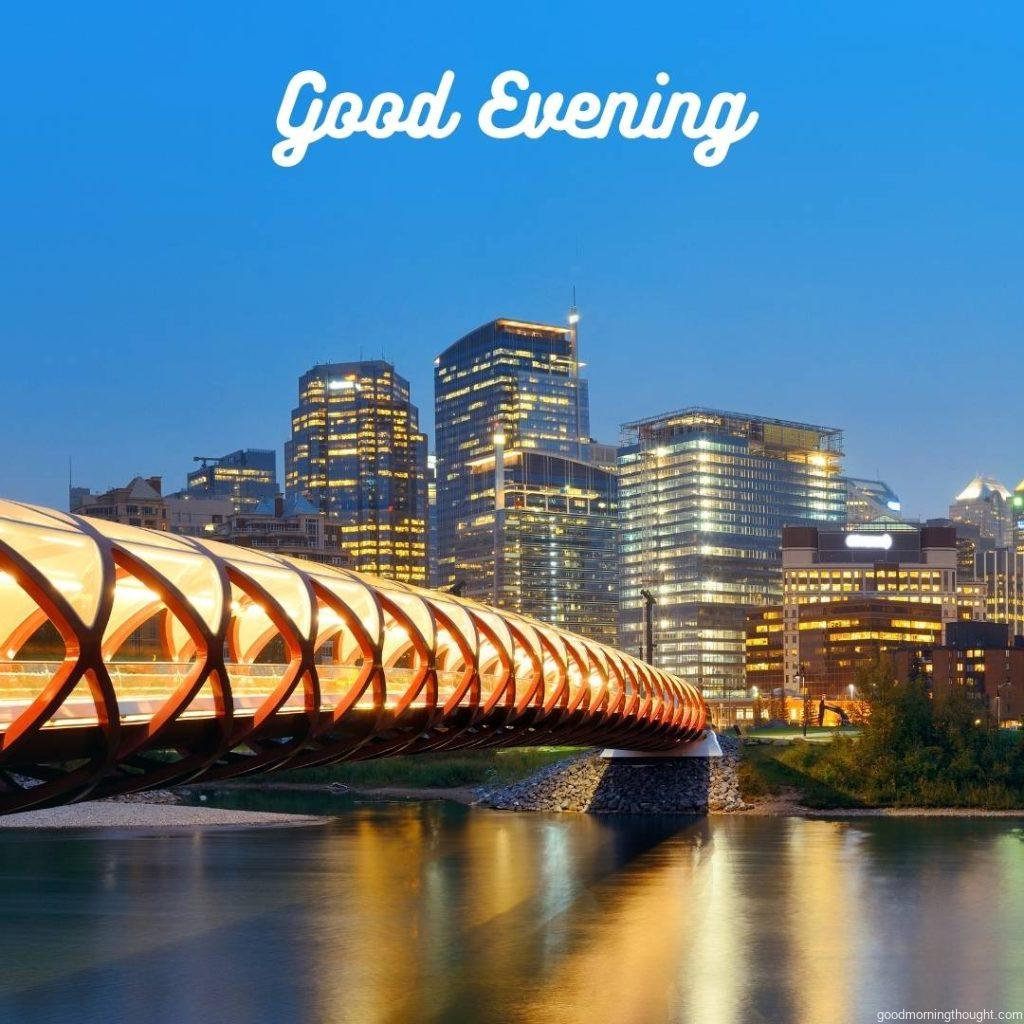 Calgary cityscape with Peace Bridge and downtown skyscrapers in Alberta, Canada, at night with _Good Evening_ text