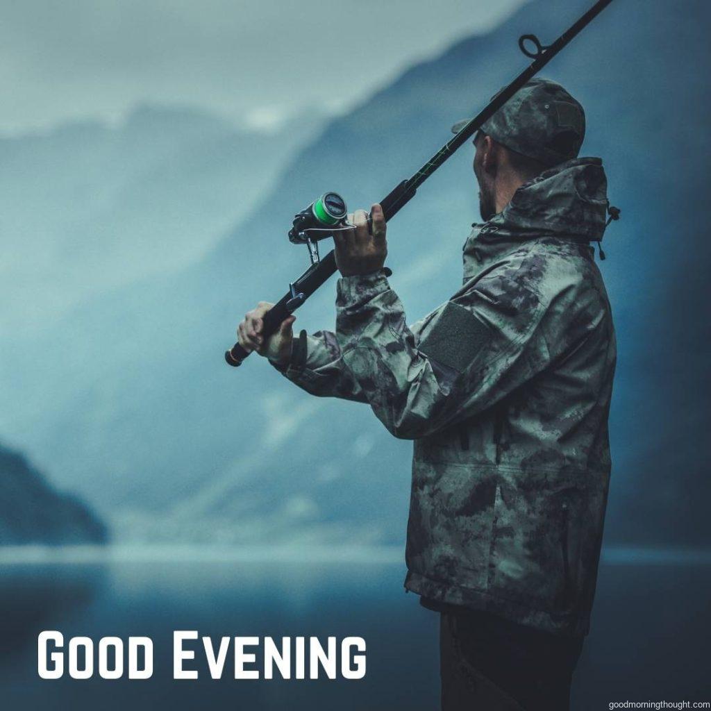 Evening Fly Fishing time A Caucasian Fisherman with a Fishing Rod on the Glacial Lake Shore with _Good Evening_ text