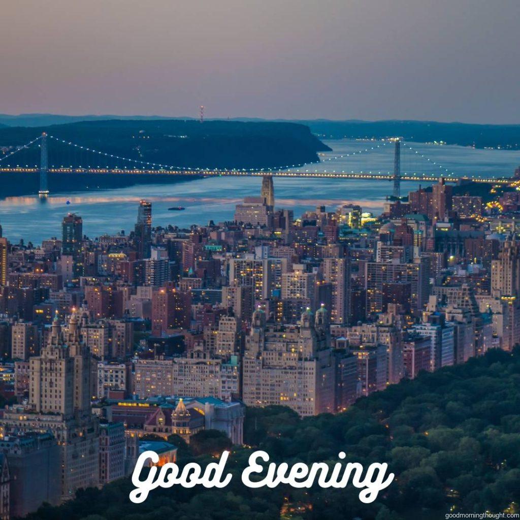 Good evening view of the city on the bank of the river with the _good evening_ text