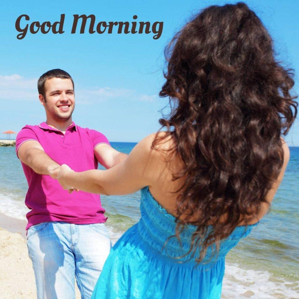 Happy young couple in casual clothes at the beach in sunny weather, good morning text