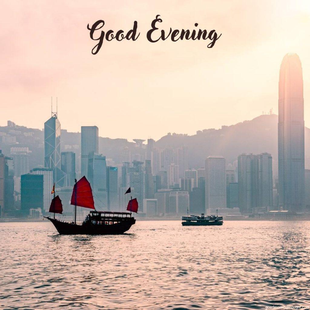 Junk boat in Hong Kong at Victoria harbour in the evening with _Good Evening_ text