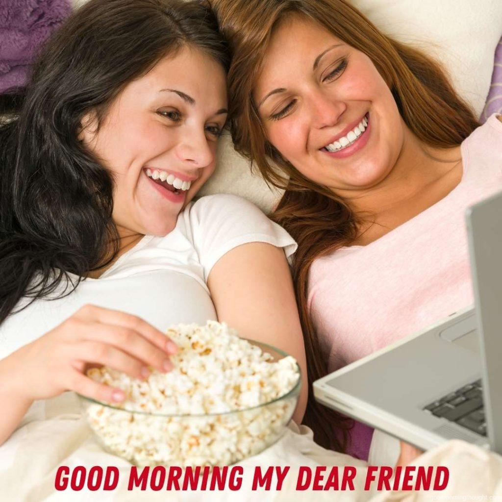 Pretty sisters lying on bed watching funny movies, good morning images for friends