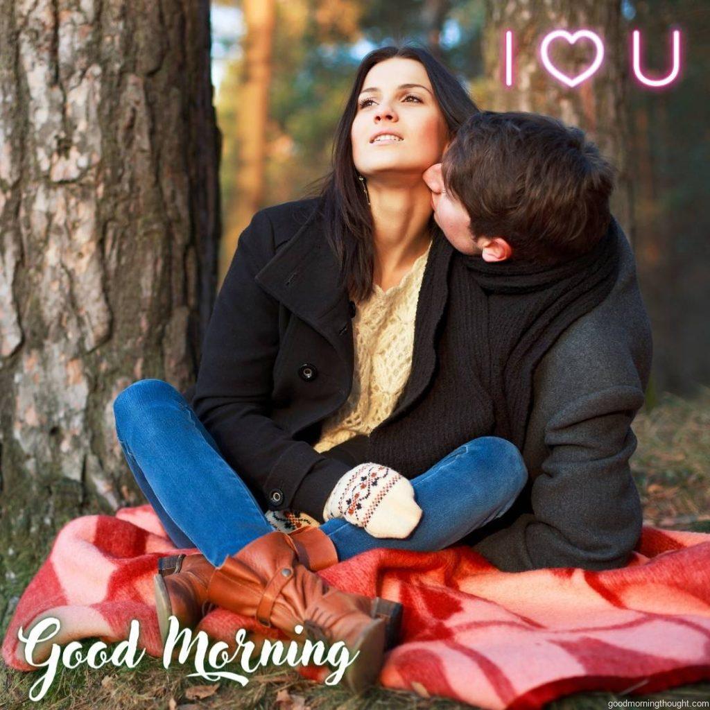 Romantic Couple in Park sitting on blanket and kissing, Love Romantic Kiss Good Morning Image