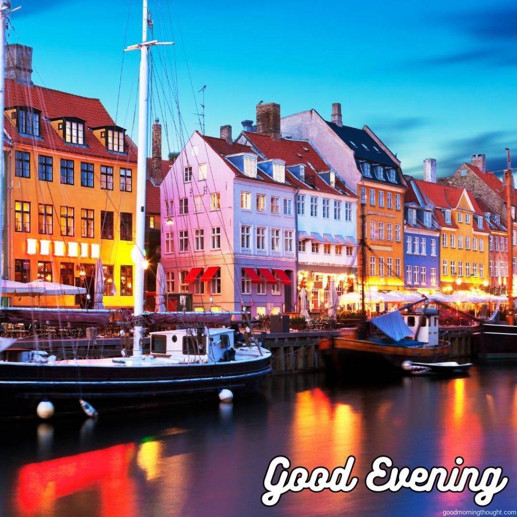 Scenic evening panorama of famous Nyhavn pier architecture in the Old Town of Copenhagen, Denmark, with _Good Evening_ text