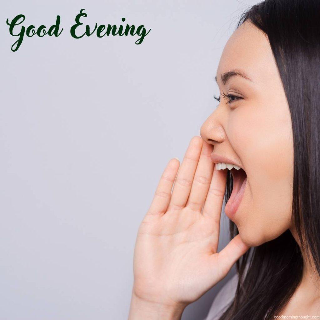 Side view of a beautiful young woman shouting and holding her hand near her mouth Sharing good news in the evening, _good evening_ text