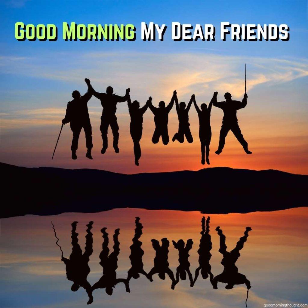 Silhouette of jumping friends on the beach, Good morning text