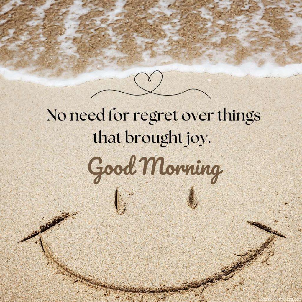 Smile drawn on the sand on the beach with a good morning text with an inspirational thought