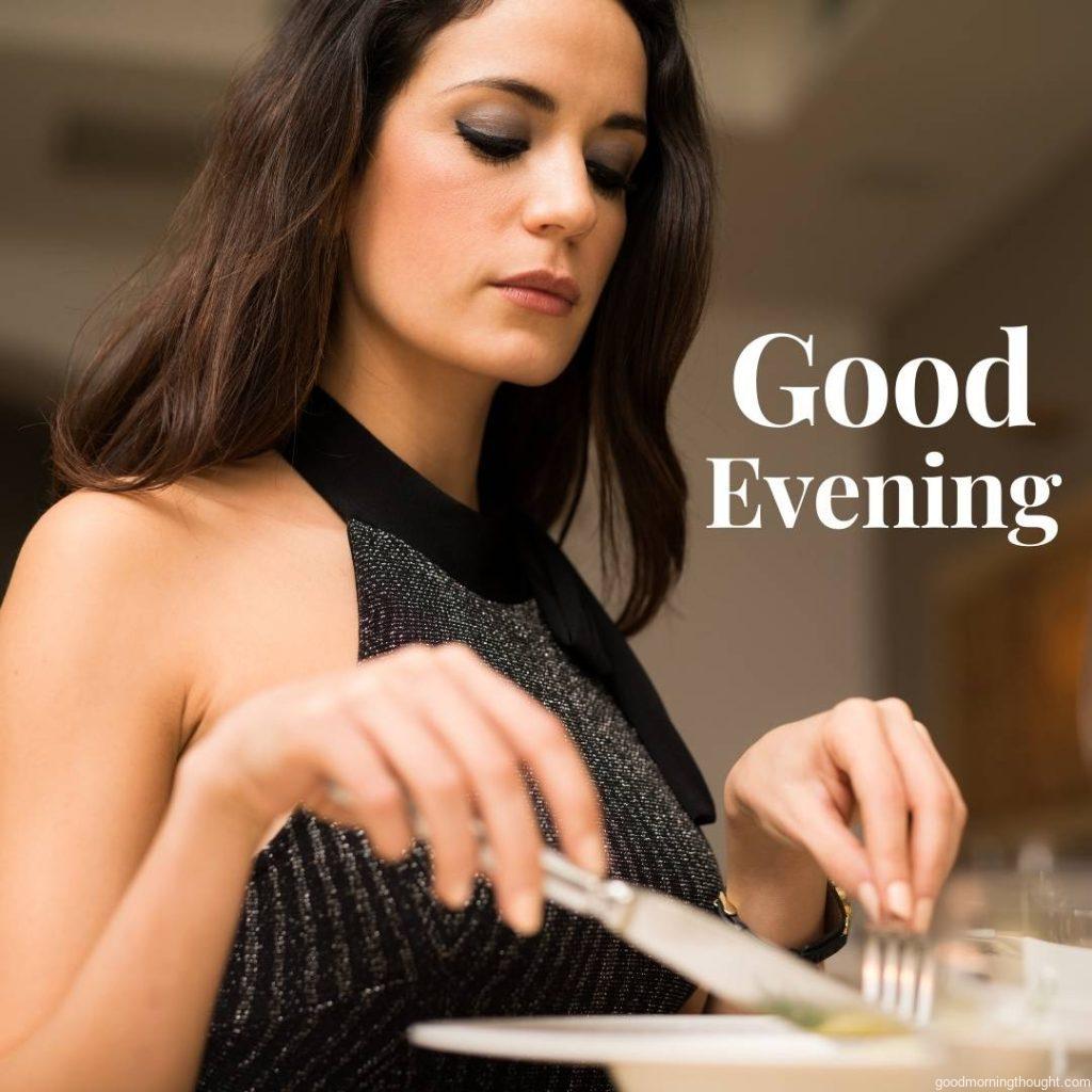 Woman eating dinner in a restaurant, Good Evening Images