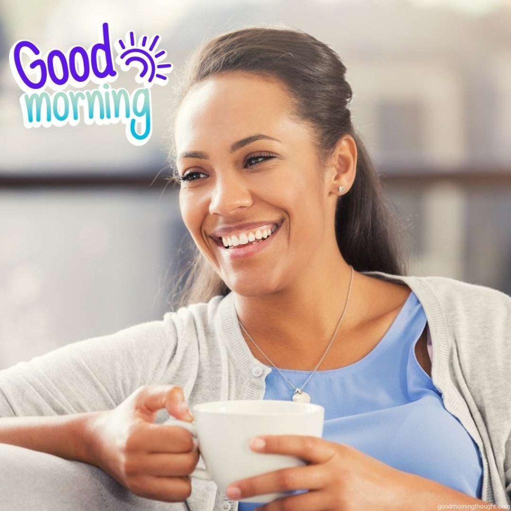 A beautiful African American woman enjoys morning coffee. African American Good Morning Images