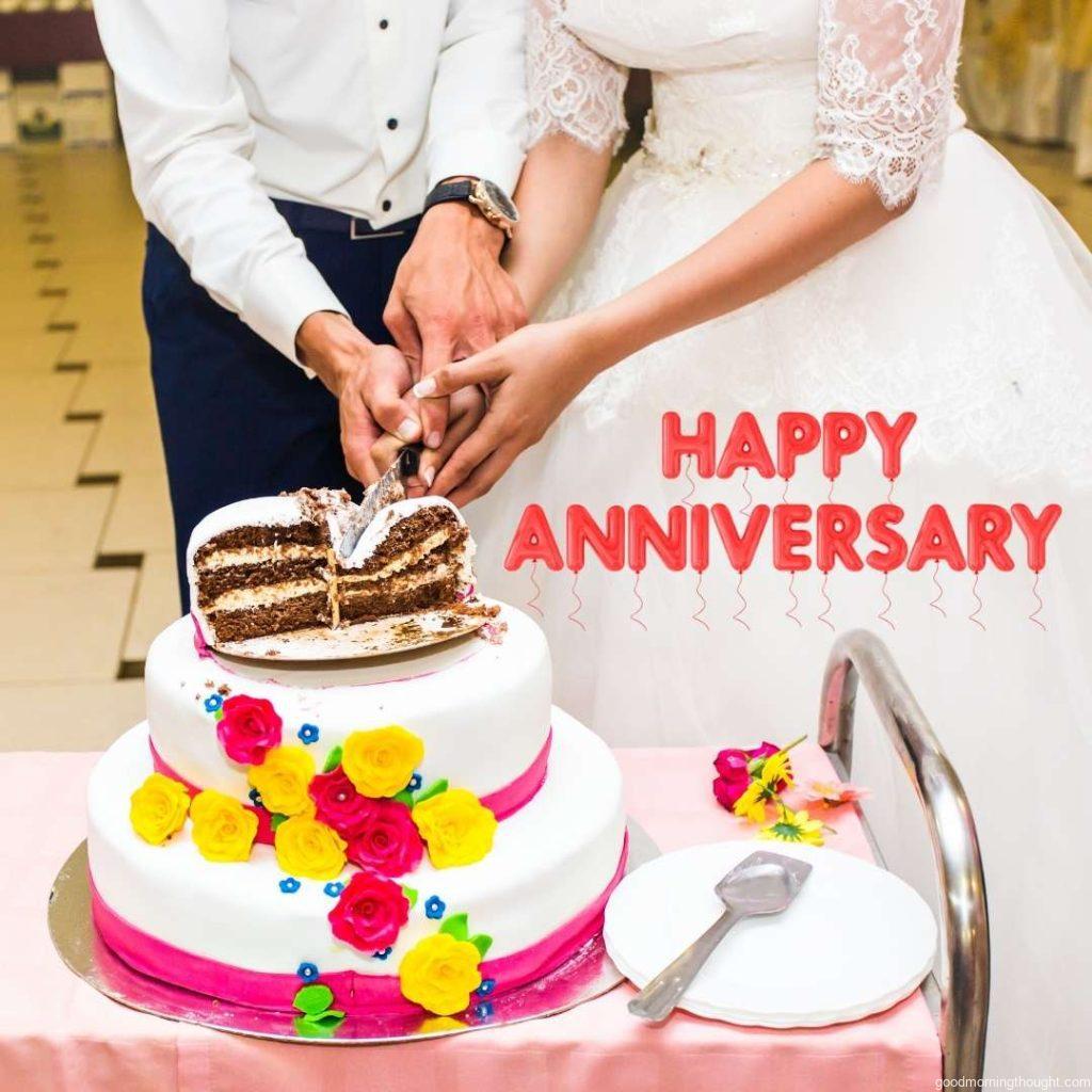 A bride and a groom are cutting their wedding cake. Happy Wedding Anniversary Images