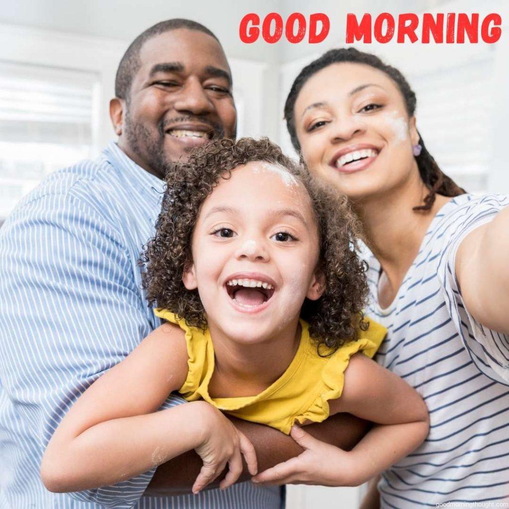 A cheery family smiles as they take a selfie in their home. African American Good Morning Images