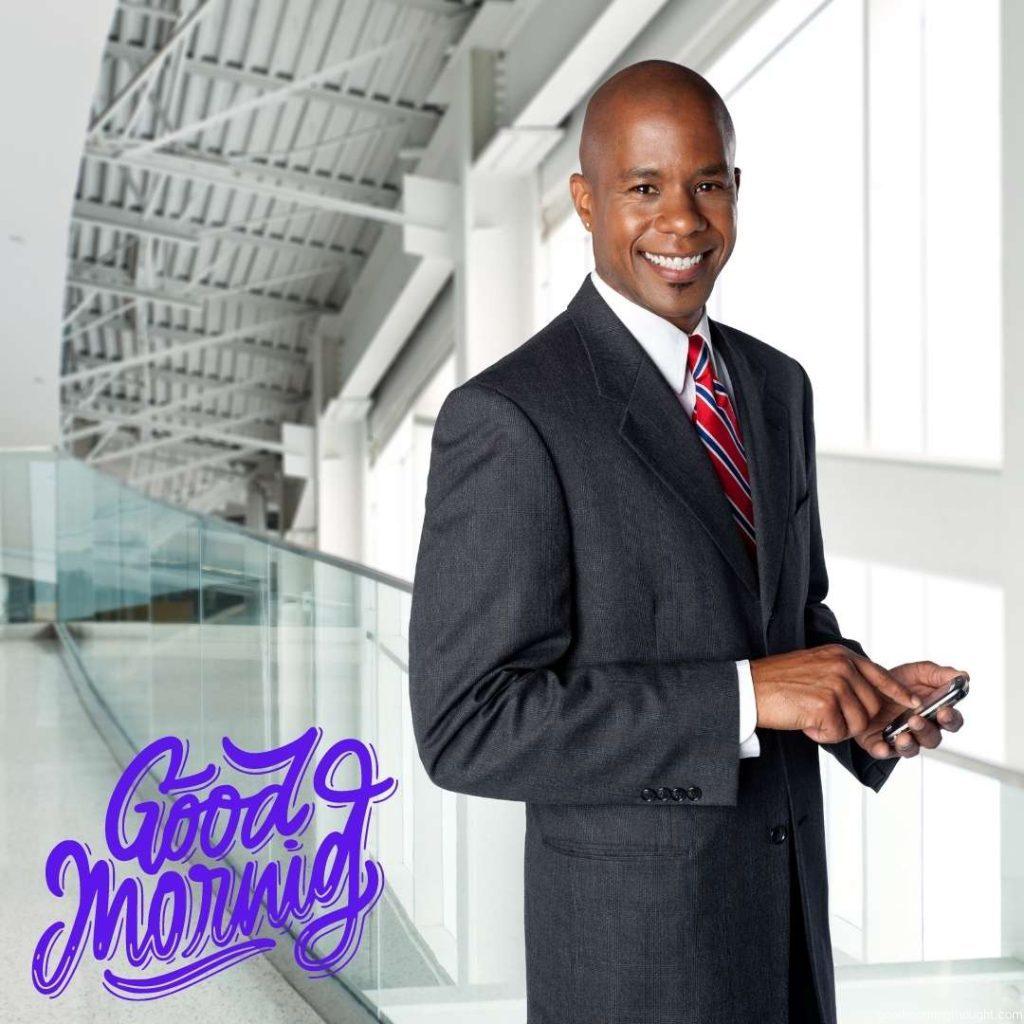 A confident, smiling African American businessman is texting on his cell phone. Good Morning text