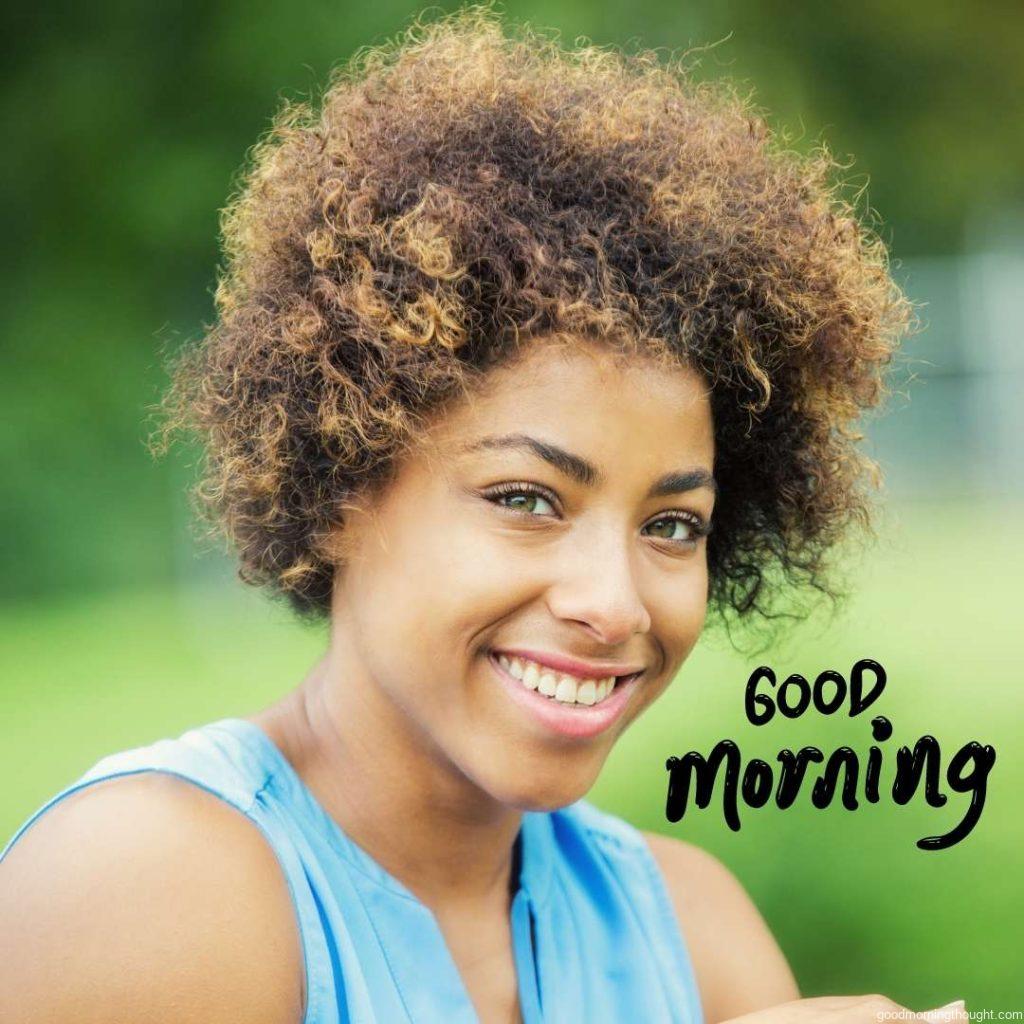 A confident young African American woman smiles while spending time outdoors. African American Good Morning Images