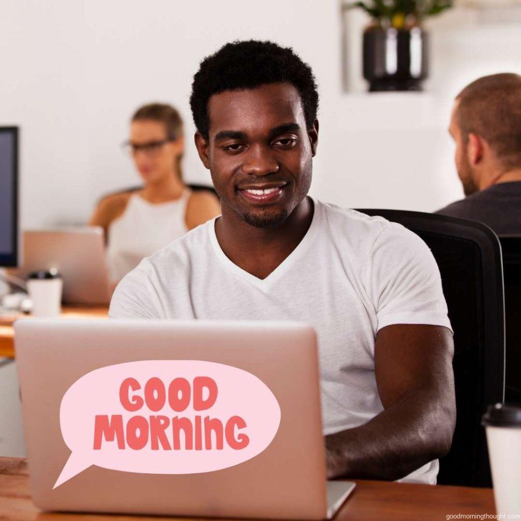 A young African American entrepreneur works on a laptop in a tech startup office. African American Good Morning Images