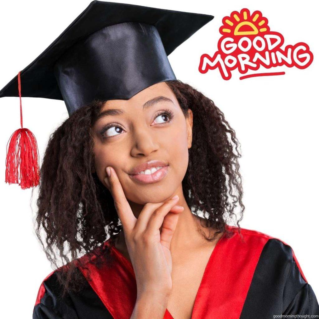 A young Afro-American female student dressed in a black graduation gown, Good morning text