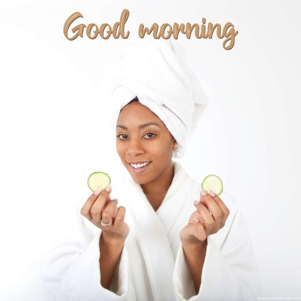 African American Woman at the spa with cucumbers for her eyes Good Morning text