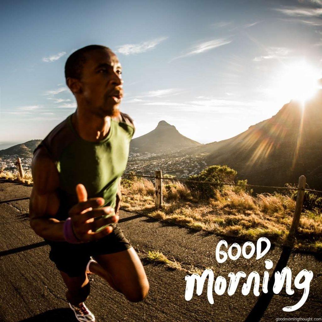 African American athletes running along a mountain road with the morning sun shining, shot with a wide-angle lens, Good morning text