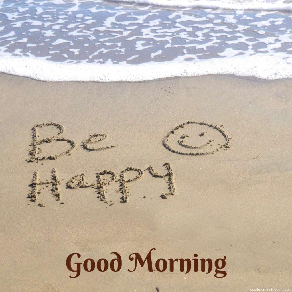 'Be happy,' a message written in the sand at the beach Word Good Morning